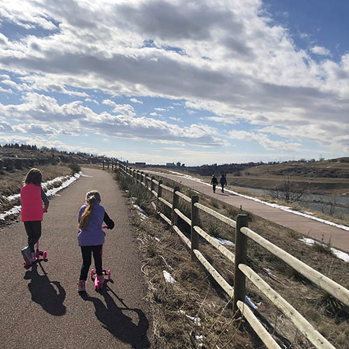 Children using scooters on Rivers Edge Trail