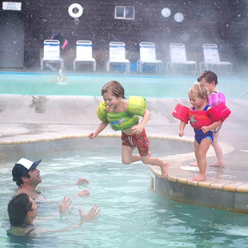 Family swimming in mineral waters of Spa Hot Springs
