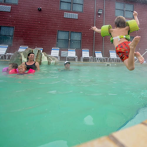 Family swimming in mineral waters of Spa Hot Springs